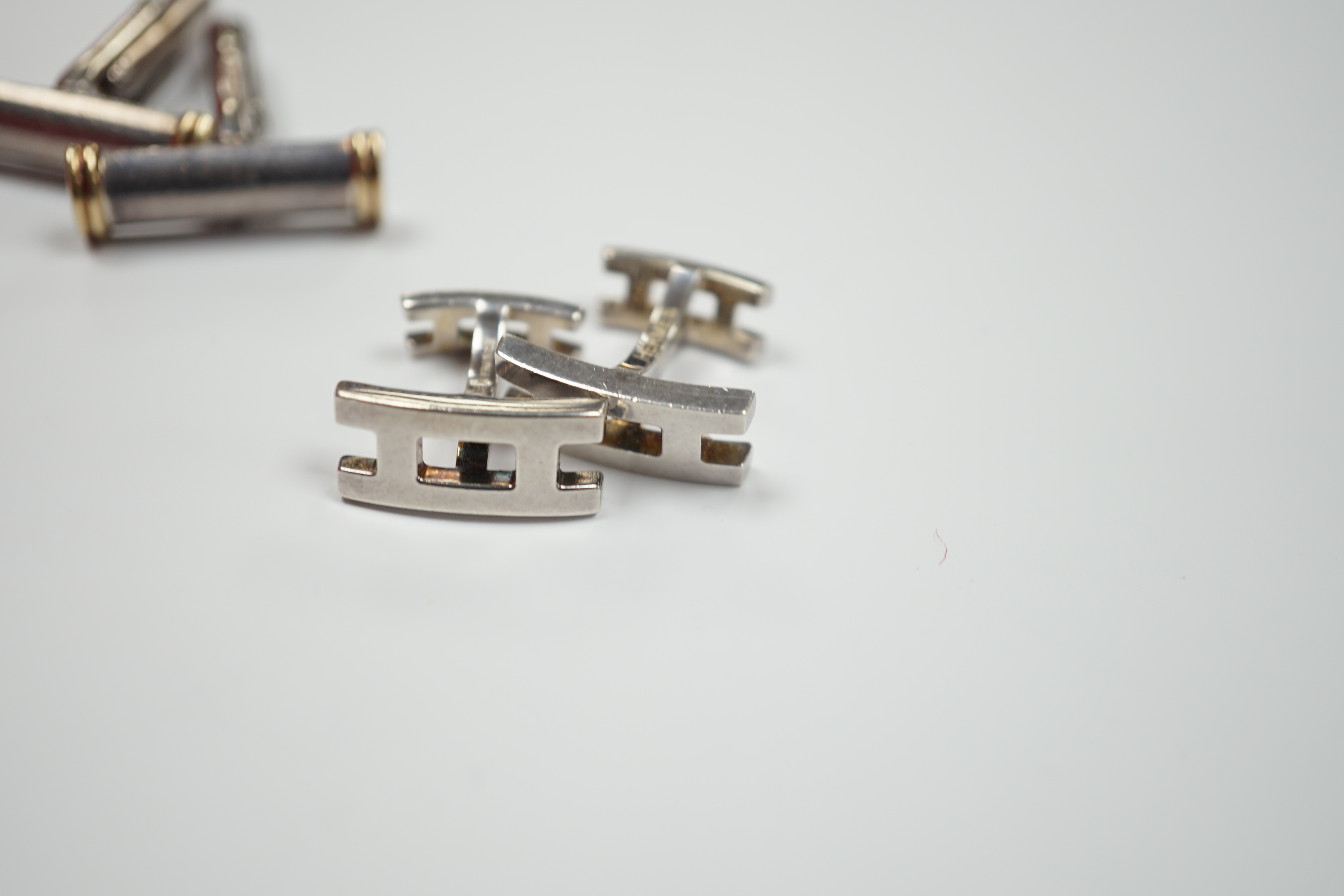 A pair of Tiffany & Co, 925 and 18k baton shaped cufflinks, 22mm and a modern pair of Hermes silver cufflinks.